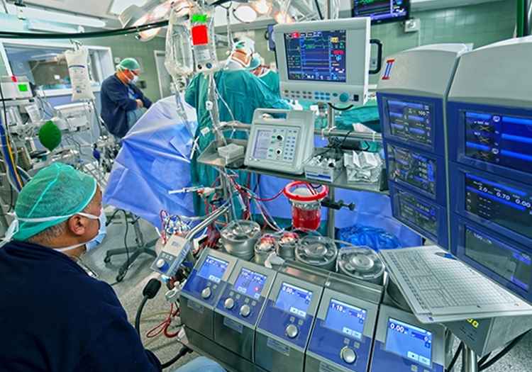 Medical operating room with advanced equipment and monitors showing vital signs during a surgical procedure